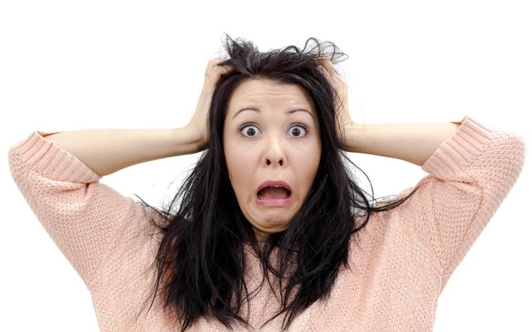 Headshot of hysterical Caucasian freckled student girl looking in despair and panic, being late for important exam or event, not knowing what to do, hands on her head, mouth wide open