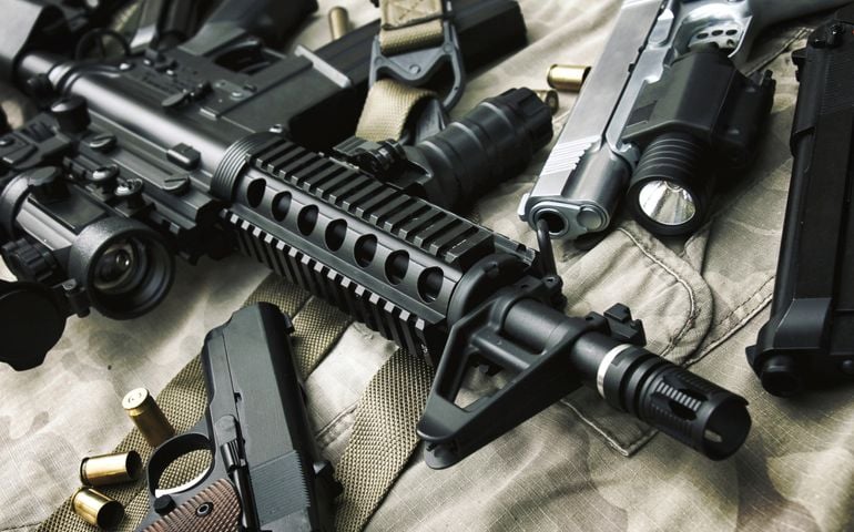 Weapons and military equipment for army, Assault rifle gun (M4A1) and pistol on camouflage background.