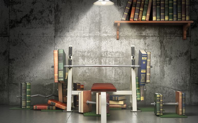 Concept of education. Training apparatus with books as barbells. Training your mind. 3d illustration