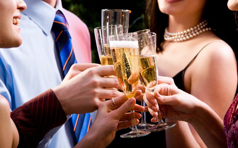 Image of human hands holding the glasses of champagne making a toast