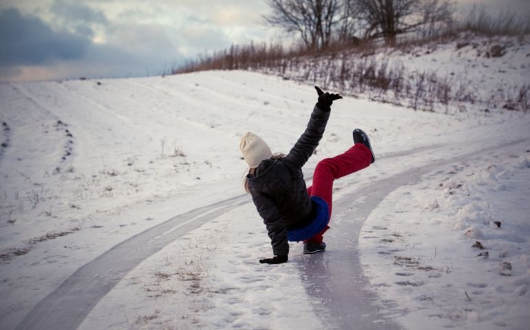 Slip on the slippery ice and snow on the road track at the country in freezing winter day