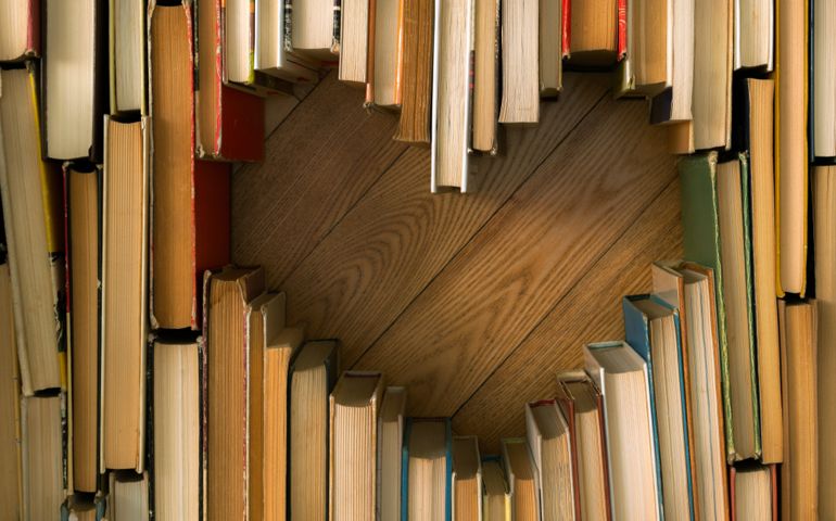 Love concept of heart shape from old vintage books on wooden floor background