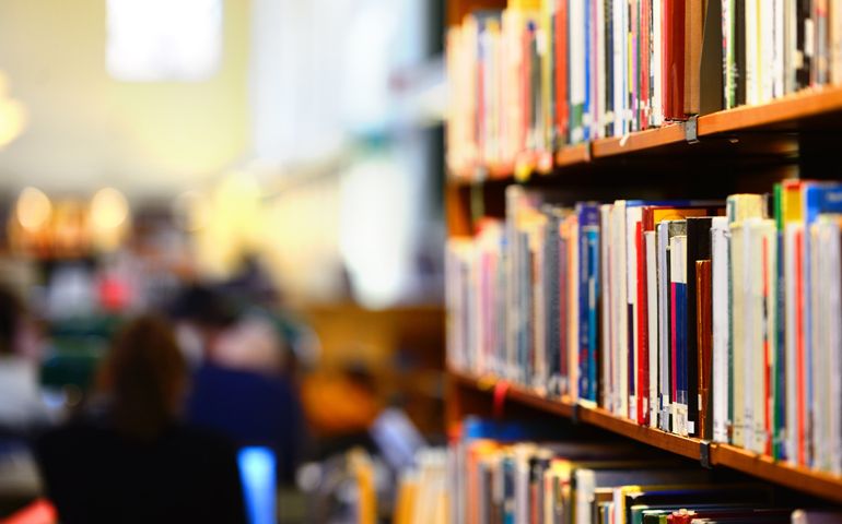 Books in public library, shallow DOF.
