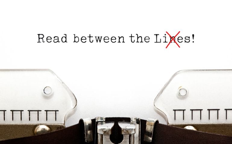 Text Read Between The Lies typed on vintage typewriter. The usually used word in the original idiom Lines is changed to Lies.