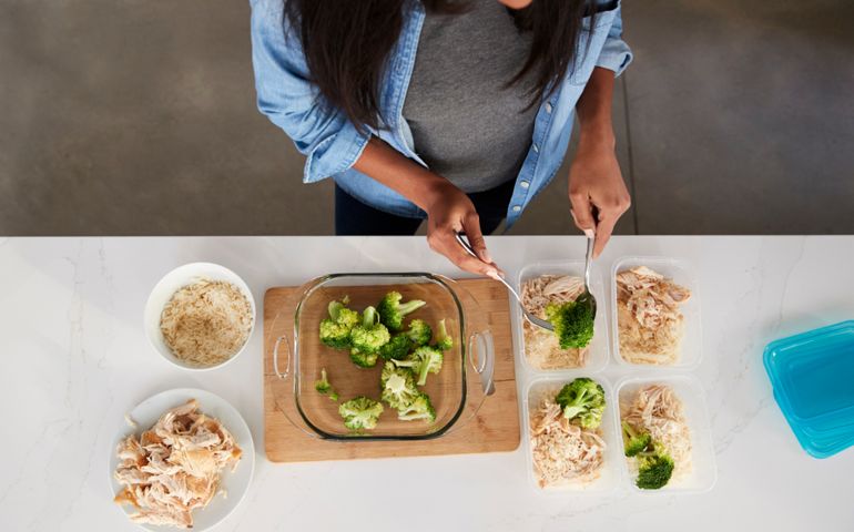 Overhead View Of Woman In Kitchen Preparing High Protein Meal