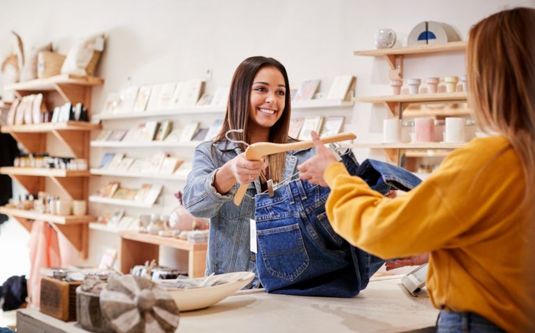 Female Sales Assistant In Independent Clothing And Gift Store Serving Female Customer