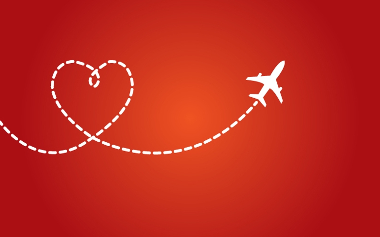 A Airplane flying in the dark red sky leaving behind a love shaped smoke trail
