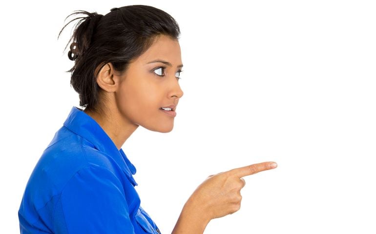 Closeup side view portrait of young unhappy, serious woman pointing at someone as if to say you did something wrong, bad boy, isolated white background. Negative emotions, facial expressions, feelings