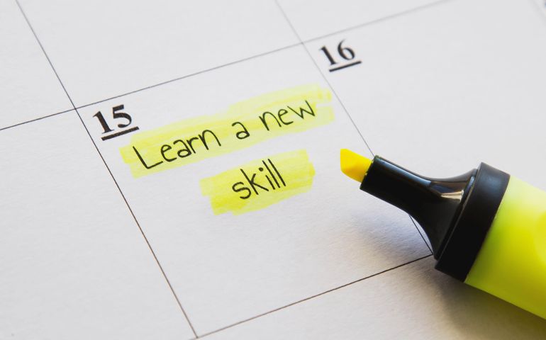 Planner calendar stamp with learn a new skill caption highlighted in yellow marker