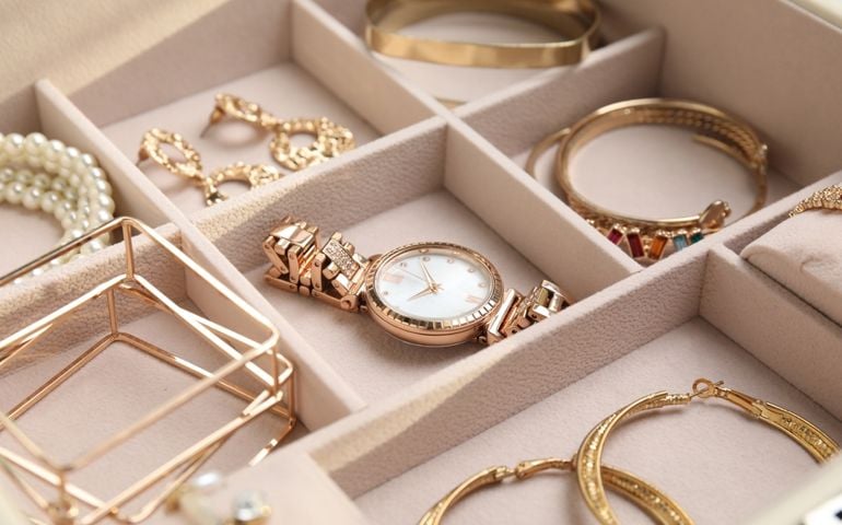 Jewelry box with stylish golden bijouterie, closeup view