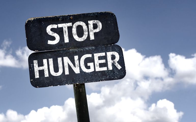 Stop Hunger sign with clouds and sky background