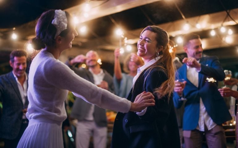 Couple Celebrate Wedding at an Evening Reception Party with Diverse Multiethnic Friends