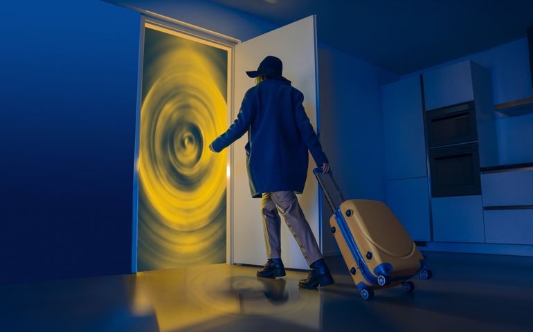 The door is like a portal for travel. Portal to other dimensions. Surrealistic creative work about future travels. The man with the suitcase walks towards the gate in the doorway. Fast travel