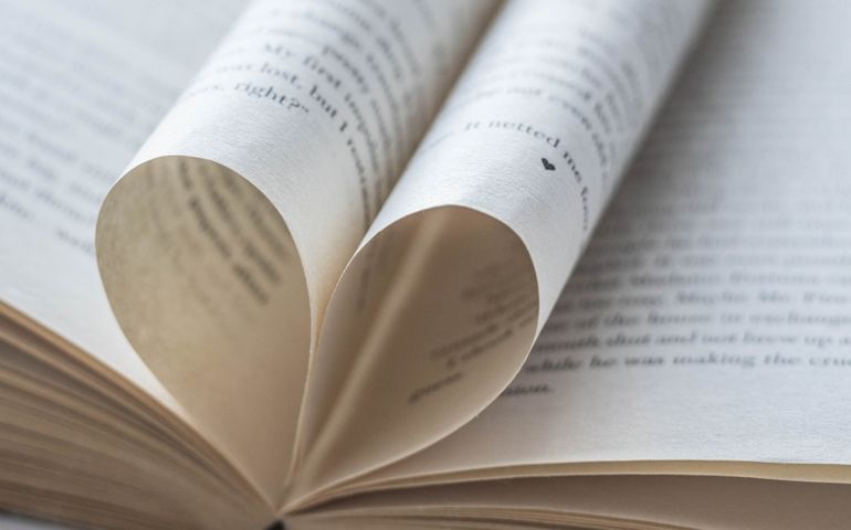 Love of books, reading. An open book with folded pages of books in the shape of a heart. Knowledge Day, Teacher's Day. Library. Reading books.