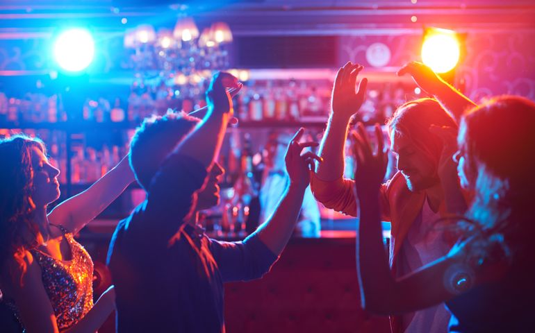 Portrait of happy friends dancing at party
