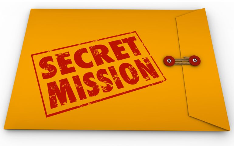 Secret Mission words in red ink stamped on a yellow envelope to illustrate an assignment or objective, job or task given to you for spying or espionage