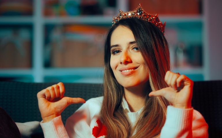 Woman Wearing a Princess Crown Feeling Special and Important. Self-absorbed person pointing to herself boosting her ego