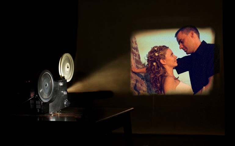 Film projector projecting a movie. Love couple on a screen. Film festival concep