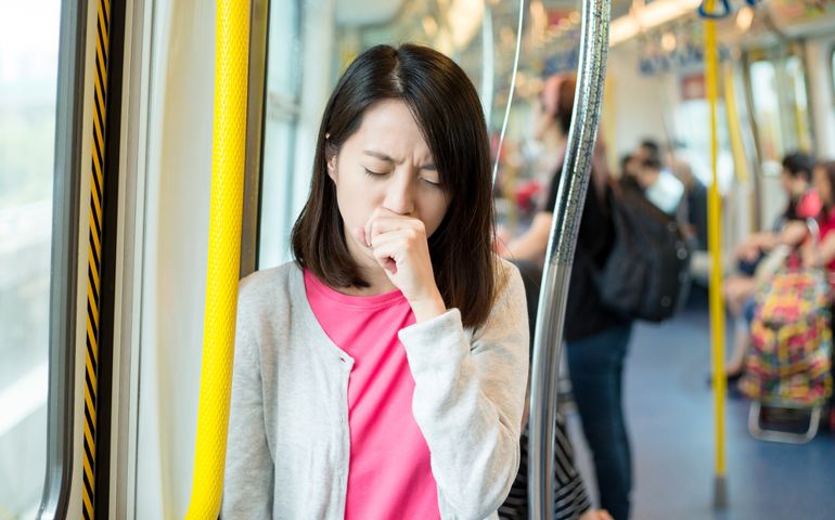 Woman feeling unwell inside train