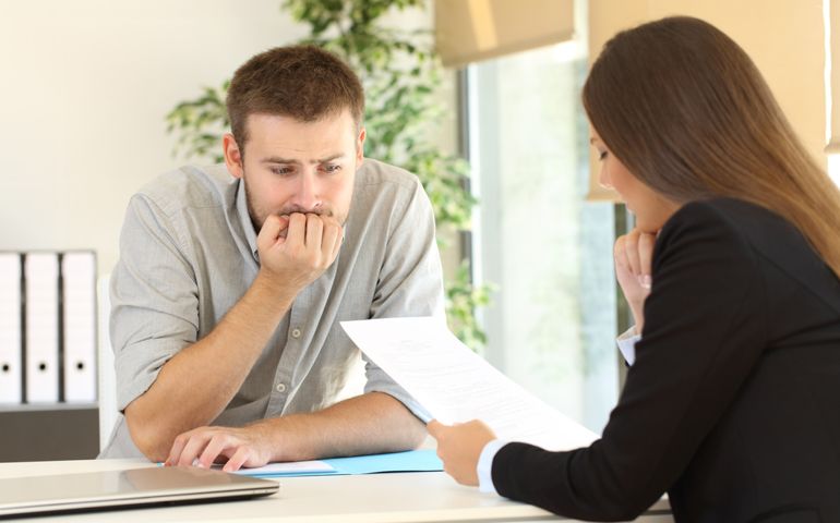 boss critisicing employee on his paper