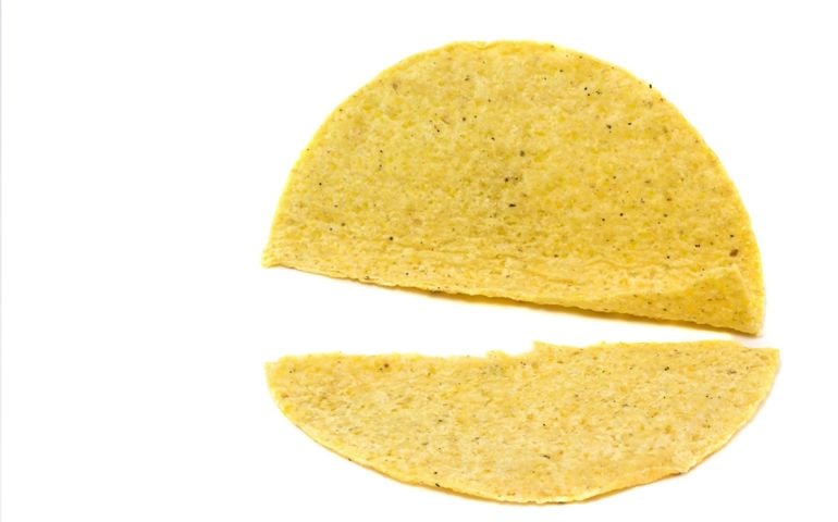 Broken yellow corn taco shell,empty.