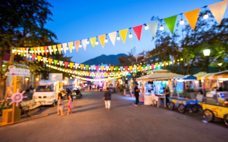 Blurred background : people shopping at market fair in sunny day, blur background with bokeh