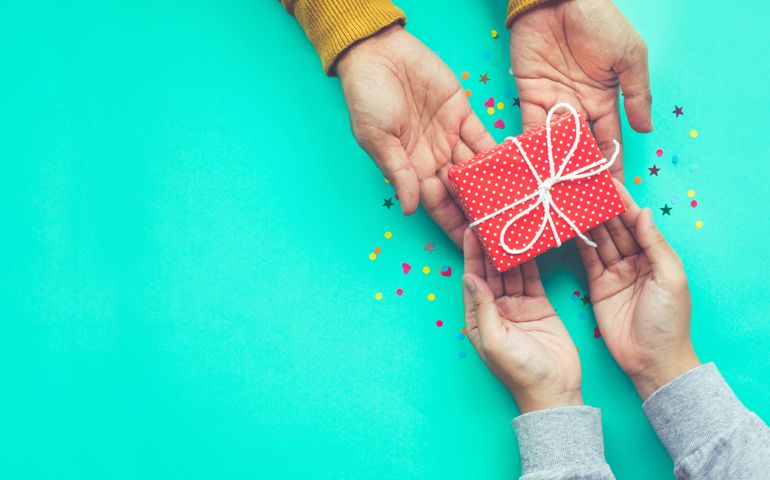 Male gives a gift to female with copy space background.happiness moment concepts ideas