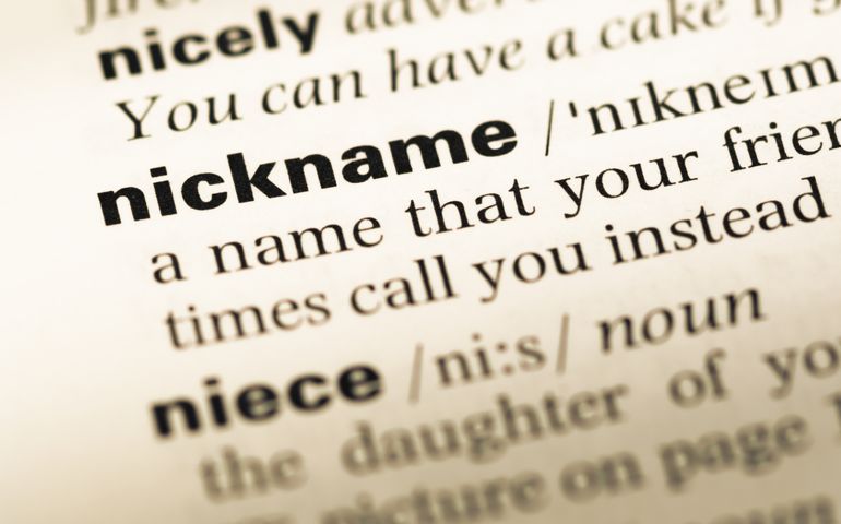 Close up of old English dictionary page with word nickname