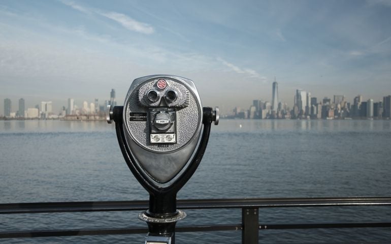 Viewing binoculars overlooking New York, Manhattan from Liberty Island