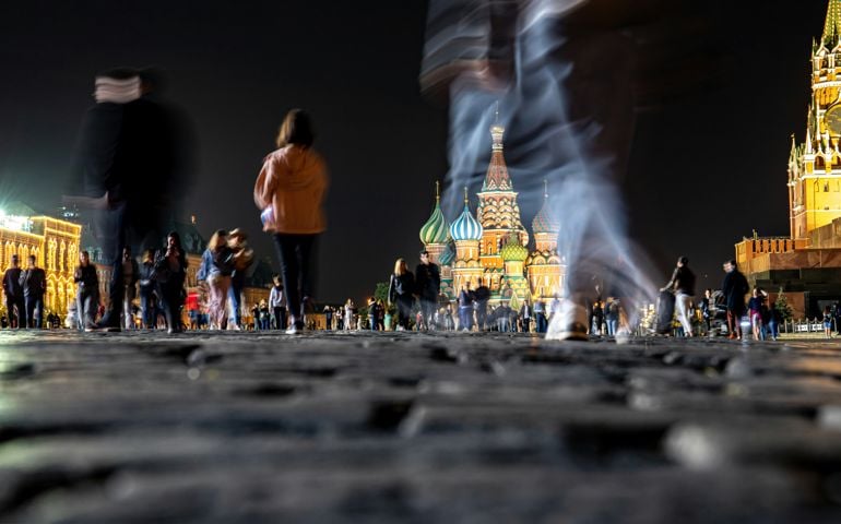 Basil's Cathedral and Spasskaya Tower on Red Square at night and people walking