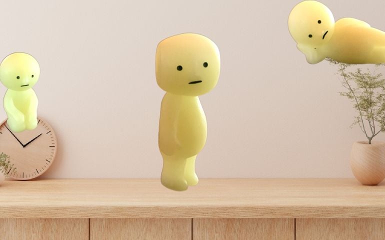 Three glow-in-the-dark Smiski figurines, each with a simple, quiet expression, perch or lounge on a minimalist shelf—capturing the subtle, quirky personalities explored in this "Which Smiski Are You?" quiz.
